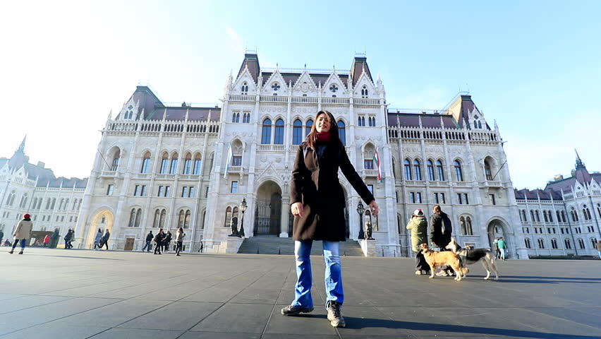 Tourist girl spinning in front of Parliament building in Hungary