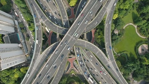 Overhead aerial drone view of the enormous Yan'an elevated freeway intersection, one of the busiest converging road junctions in Shanghai, urban China