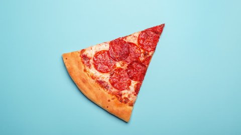 eating delicious pizza pepperoni slice, time-lapse on blue background