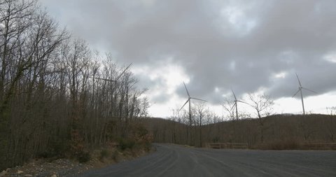 Wind farm towers turbine on the mountain to produce clean and renewable electric energy. 