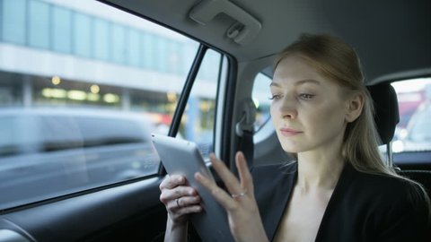 Blonde Woman Touching her Hair in the Immobile Car