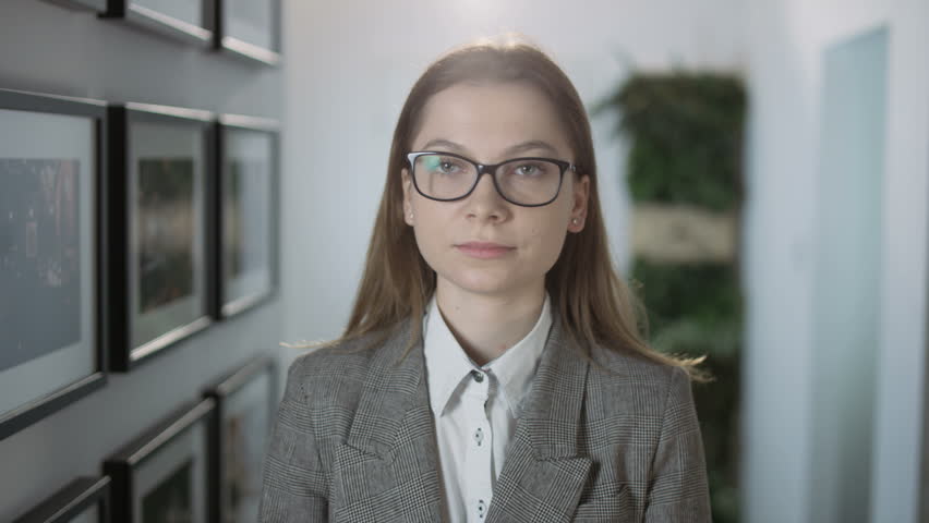 Young Businesswoman Standing and Turning Head Around