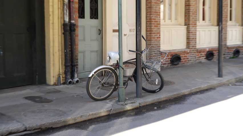 Zoom in on an old bicycle parked in the street