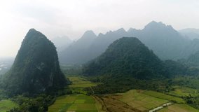 
4k Video shot aerial view by drone. Landscape Mountain of Vang Vieng village with limestone mountains, Laos