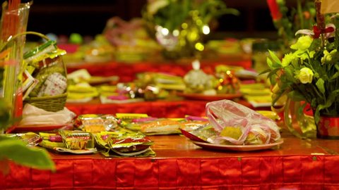 Taipei, Taiwan-10 February, 2016: Great variety of offerings and gifts placed on the tables inside of the Dalongdong Baoan Temple in Taipei, Taiwan. There are fruits, food and flowers.