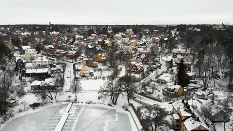 Aerial view of residential area "Appelviken" in Stockholm on a wintry day. Zooming out.