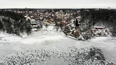 Aerial view of residential area "Appelviken" in Stockholm on a wintry day. Zooming in.