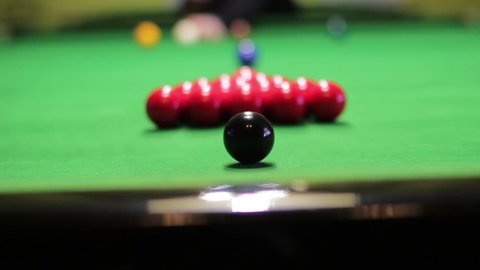 The initial blow to the pyramid of balls in snooker