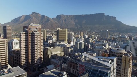 Cape Town, South Africa - 01/01/18: Drone flies above city towards Table Mountain at sunset