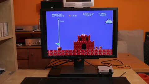 BUDAPEST, HUNGARY - FEBRUARY 17, 2018: Playing Super Mario Bros, the classic Nintendo NES game from the 80s