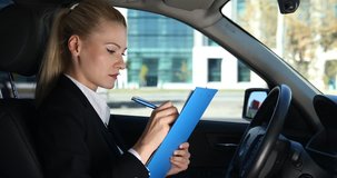 Corporate Business Woman Taking Notes on Clipboard Checklist Report Inside Car