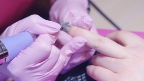 Slow motion. hardware manicure. removal of nail polish with a rotating nail file.
