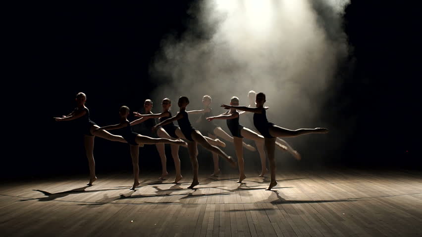 Young teen girls perform ballet on stage in smoke on black background. A choreographed dance of a group of graceful pretty young ballerinas practicing on stage in a classical ballet school. | Shutterstock HD Video #1008452200