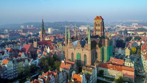 Gdansk, Poland. Aerial 4K reveal video of old city, Motlawa river and famous monuments: Gothic St Mary church, city hall tower, the oldest medieval port crane (Zuraw) and old houses
