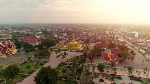 
4k Video shot aerial view by drone of Wat Phra That Luang , Vientiane, Laos PDR. sunrise on Lao landmark temple.