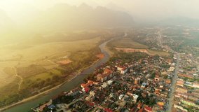 4k Video shot aerial view by drone. River at the village of Vang Vieng on Laos. Sunset landscape