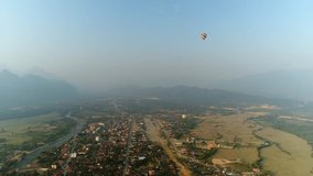 4k Video shot aerial view by drone. River at the village of Vang Vieng on Laos. Sunset landscape Balloon