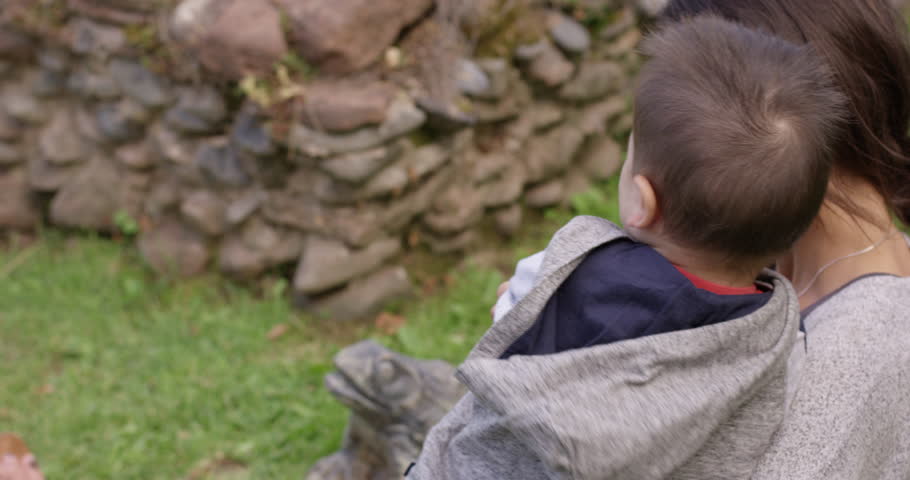 Toddler and mother cuddling in park