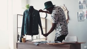 Tailor at work, measures the long sleeve with measuring line, writes down the numbers into his notepad. Modern, creative fashion studio. Trendy clothes, new collection, being busy. Slow motion - Powered by Shutterstock - Get 15% off with code: PIKWIZARD15