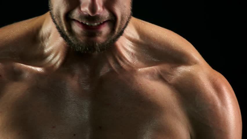 Close up muscular sweaty chest of sportsman. Toned male body doing exercises with rubber band close up. Hard efforts in muscles building. Royalty-Free Stock Footage #1008478891