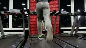 
In the Gym: Treadmill, close up video. Young man jogging