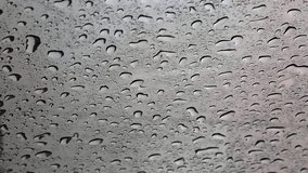 Raindrops on the car window. playing of raindrops