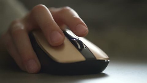 The boy's hand on a computer mouse. Work is close-up 4K
