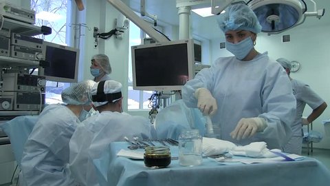 Ukraine.Lviv.28.02.20018. surgeon performs an operation on the labia in a woman in a gynecological chair. table with surgical instruments. nurse in gauze mask. patient on the operating table