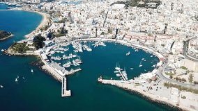 Aerial drone bird's eye view video of iconic round shaped port of Mikrolimano with boats docked, Piraeus, Attica, Greece