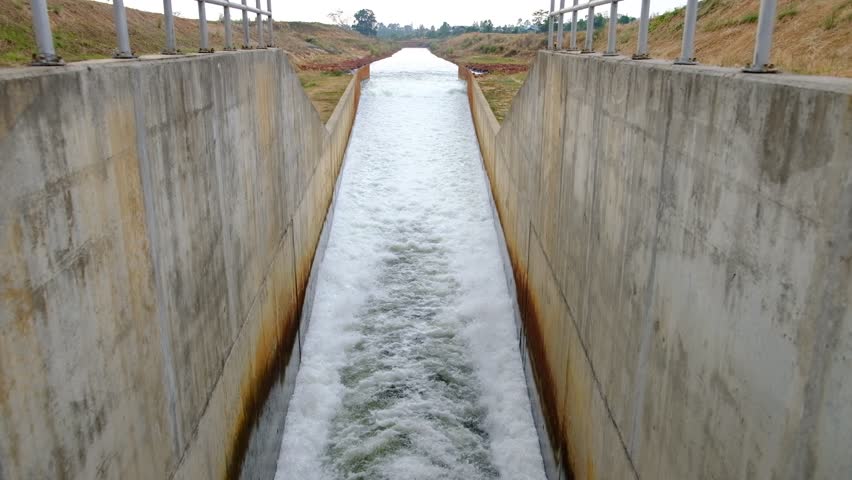 Water flows out of the dam.