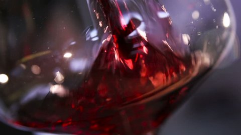 Sauvignon, cabernet or merlot splashing slow motion closeup. No people, food and drink concept of advertising, delicious footage of grape liquor juicy vinous color poured in classic wineglass