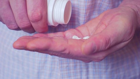 treatment with tablets. hand takes the tablets from the bottle into the palm. patient takes medication in tablets. Closeup. 1920X1080 FullHD  video