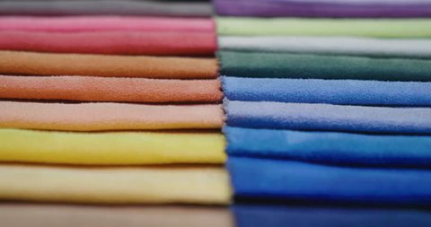 In a textile shop, there are fabrics of various colors and various materials, such as fabric, lace, satin, linen. Concept of: tailoring, colors, fabrics, clothes and fashion.
