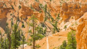 People walking along the trail. Sunny day in the Bryce Canyon National Park. Nature video. Amazing mountain landscape. Spectacular view at the cliffs. Nature video. Utah. USA. 4K, high bit rate