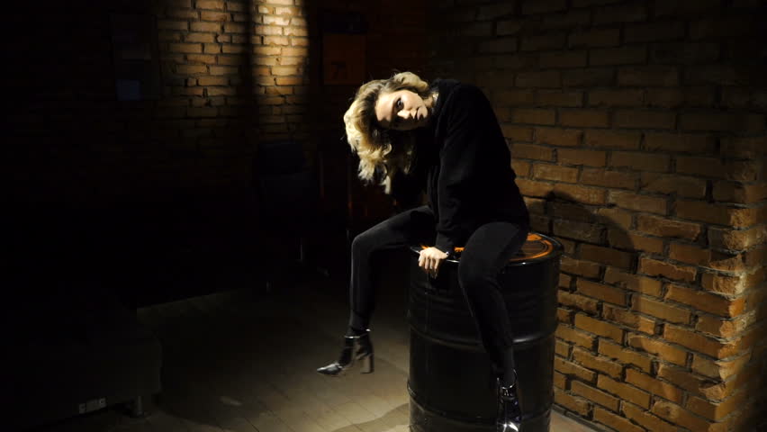 Girl is sitting on the barrel