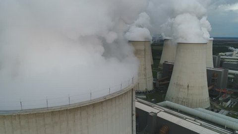 JANSCHWALDE, GERMANY - SEPTEMBER 2017: Heavy smoke billows from lignite (brown coal) fired power station, industrial complex and electricity generation facility in Germany, Europe
