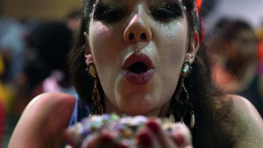 Girl blowing colorful confetti at Salvador Carnaval, Brazil | Shutterstock HD Video #1008558853