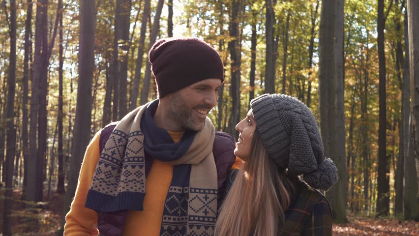 Affectionate couple talking and walking in forest