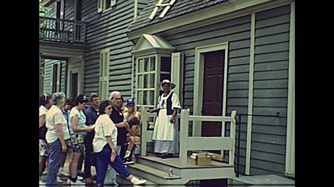 Williamsburg, Virginia, United States - in 1980: John Greenhow Store in the historical colonial Williamsburg historic town in 80s archival. Buildings from 1699 al 1780 with tourists and 1700 clothes.