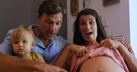 Attractive family with an adorable infant reveal they are pregnant again on a video chat call over the internet