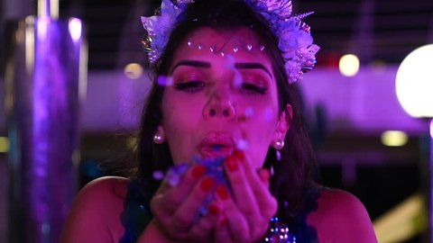 Girl blowing colorful confetti