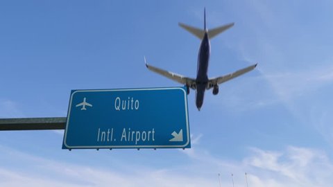 quito airport sign airplane passing overhead