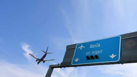 airplane flying over manila airport signboard