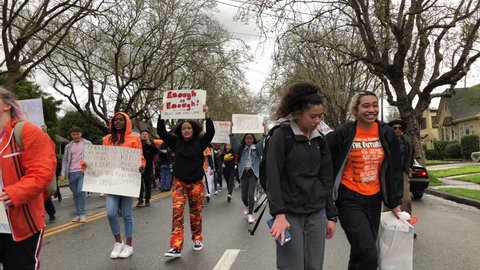 Alameda, CA - March 14, 2018: With calls to “End gun violence, no more silence!” hundreds of students from Alameda High School participate in a student walkout to protest gun violence. 4K hd video