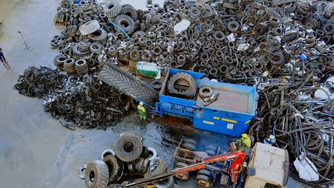 Waste recycling plant. The truck crane loads old tires into the shredder for recycling. Aerial view