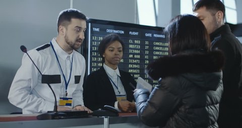 Businesspeople at counter of registration in airport arguing with multiracial officers because of visa refusal. 4K shot on Red cinema camera.