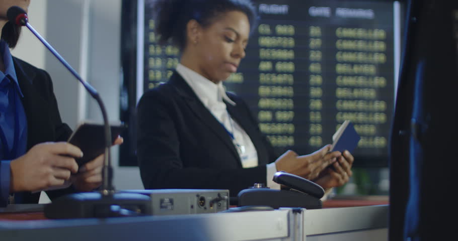 Crop view of people passing through registration counter with multiracial receptionists in airport having biometric control. 4K shot on Red cinema camera. Royalty-Free Stock Footage #1008584797