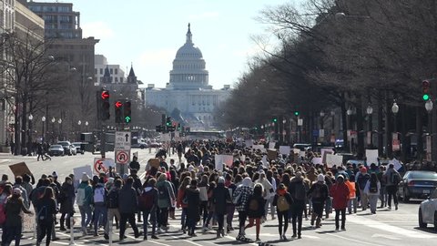 WASHINGTON, DC - MAR. 14, 2018: Students from area high schools during National School Walkout, protesting government’s inaction on gun control, march from White House to Capitol on Pennsylvania Ave.