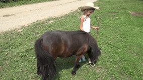 Child Looking a Grazing Pony Horse, Cowboy Farmer Girl Playing, Pasturing 4K