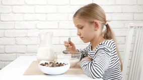 Child Eating Milk And Cereals at Breakfast in Kitchen, Girl Tasting Meal 4K